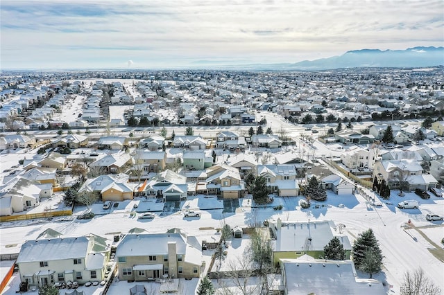 snowy aerial view with a mountain view