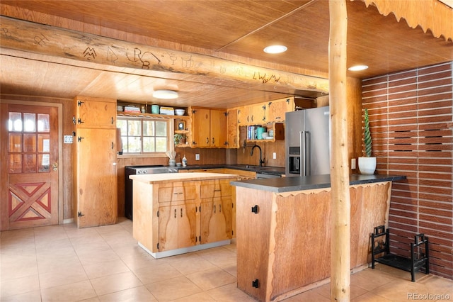 kitchen featuring high quality fridge, light tile patterned floors, sink, and wooden ceiling