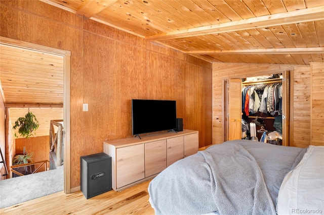 bedroom featuring wood ceiling, wooden walls, lofted ceiling with beams, and light hardwood / wood-style floors