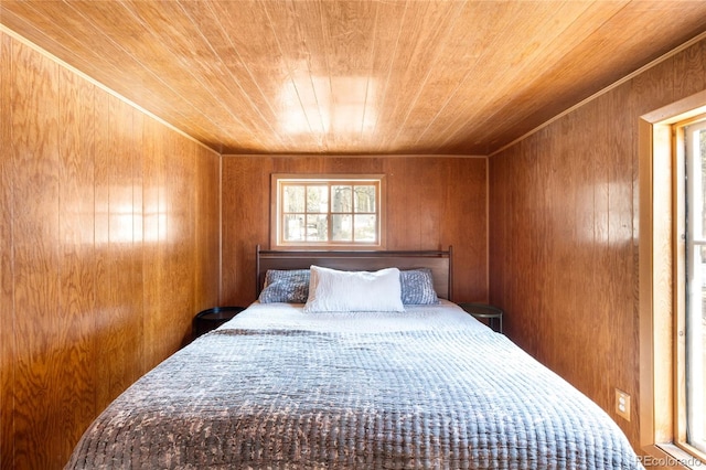 bedroom with wood ceiling and wooden walls