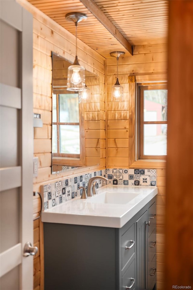 bathroom with vanity, wooden walls, beam ceiling, and wooden ceiling