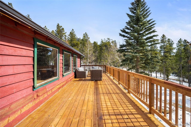 wooden terrace with an outdoor living space