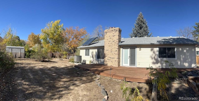 rear view of house with central air condition unit and a wooden deck