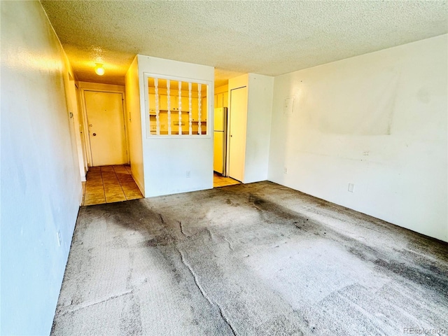 8826 E Florida Ave Unit 102, Denver, CO 80247 - carpeted empty room with a textured ceiling