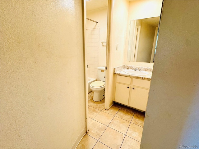 8826 E Florida Ave Unit 102, Denver, CO 80247 - bathroom featuring tile patterned flooring, vanity, and a textured wall