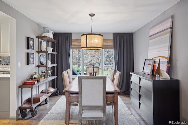 dining space featuring wood-type flooring