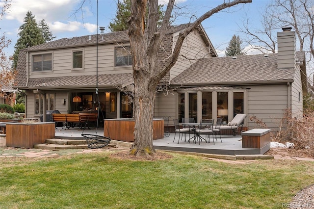 rear view of property featuring a yard and a patio