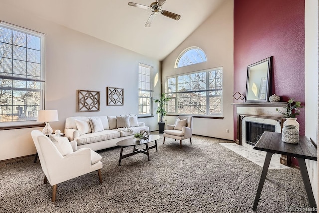 living room with ceiling fan, a premium fireplace, carpet floors, and high vaulted ceiling