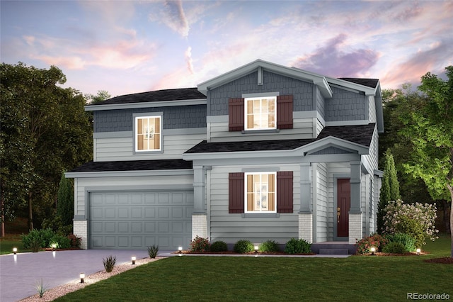 view of front of house featuring concrete driveway, a yard, and an attached garage