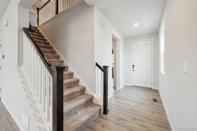 12353 E 101st Pl, Commerce City, CO 80022 - foyer entrance with stairs, light wood finished floors, and visible vents