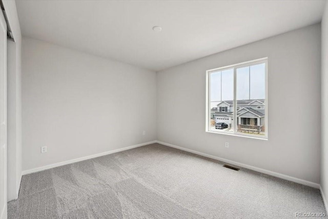12353 E 101st Pl, Commerce City, CO 80022 - spare room featuring visible vents, baseboards, and carpet floors
