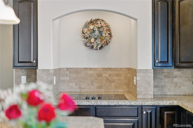 1673 Morningview Ln, Castle Rock, CO 80109 - kitchen featuring light countertops, tasteful backsplash, arched walkways, and black electric stovetop