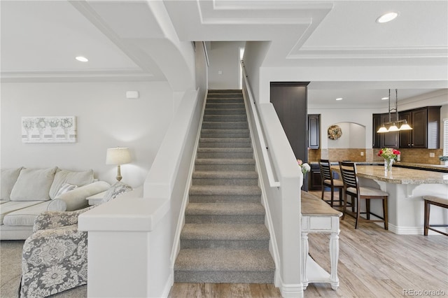 1673 Morningview Ln, Castle Rock, CO 80109 - stairway featuring wood finished floors, recessed lighting, and crown molding