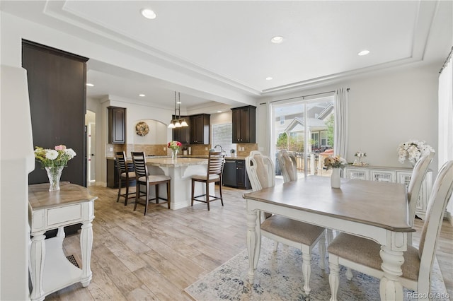 1673 Morningview Ln, Castle Rock, CO 80109 - dining space featuring a raised ceiling, recessed lighting, light wood-type flooring, ornamental molding, and a chandelier