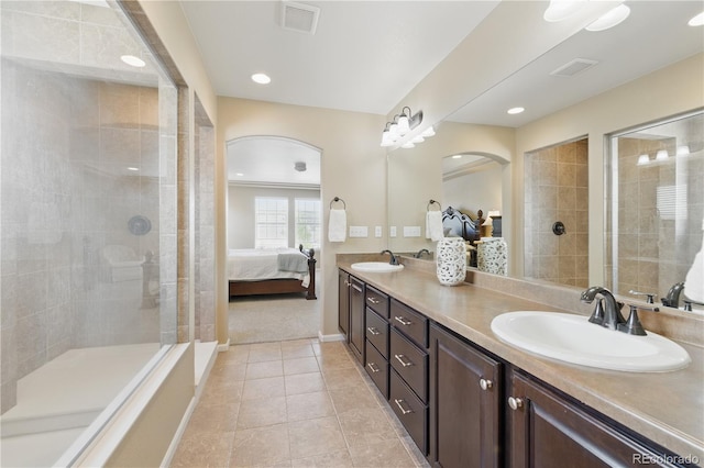 1673 Morningview Ln, Castle Rock, CO 80109 - ensuite bathroom with tile patterned floors, double vanity, a tile shower, baseboards, and recessed lighting