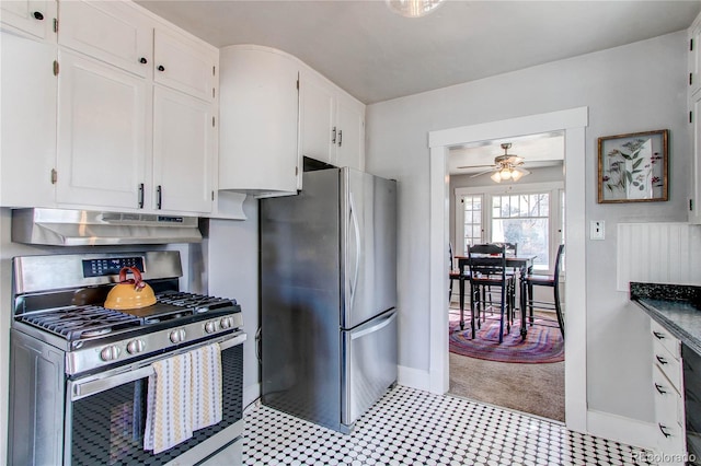 kitchen featuring dark countertops, ceiling fan, stainless steel appliances, under cabinet range hood, and white cabinetry