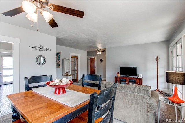 dining room with a healthy amount of sunlight, baseboards, and a ceiling fan