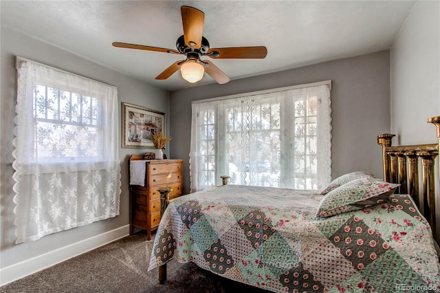 bedroom with a ceiling fan, carpet flooring, and baseboards