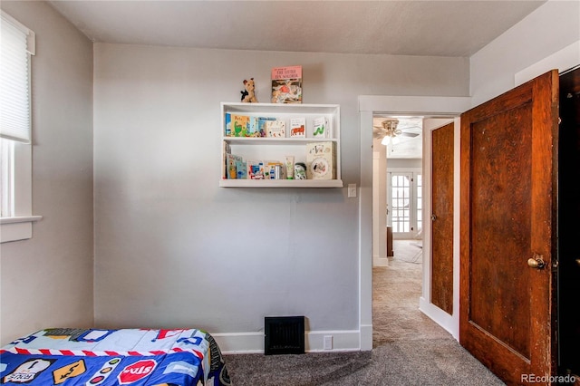 carpeted bedroom featuring baseboards