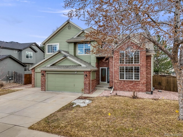 traditional-style home featuring driveway, a garage, a shingled roof, fence, and brick siding