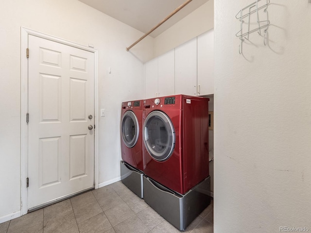 clothes washing area featuring baseboards, washing machine and clothes dryer, and light tile patterned floors