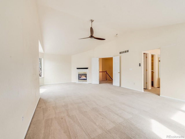 unfurnished living room with a fireplace, visible vents, a ceiling fan, light carpet, and baseboards