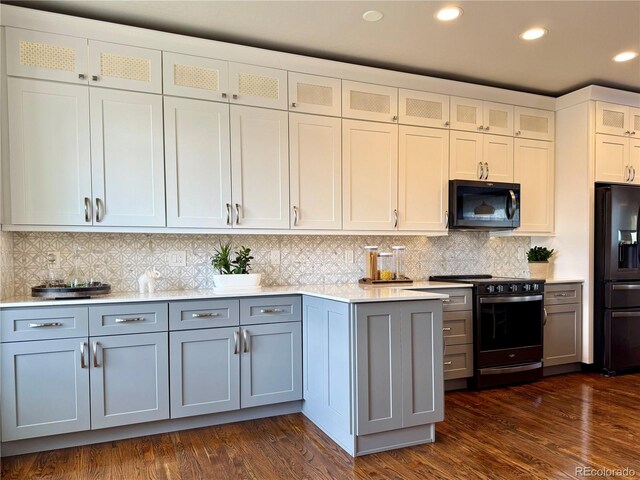 kitchen with black appliances, decorative backsplash, glass insert cabinets, dark wood-style floors, and recessed lighting