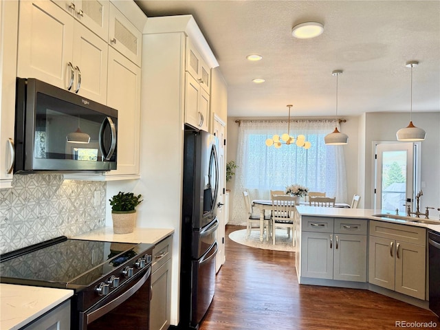 kitchen featuring gray cabinets, a wealth of natural light, fridge with ice dispenser, and black / electric stove