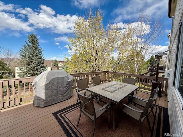 deck featuring outdoor dining area and area for grilling