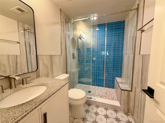 full bath with a shower stall, tile patterned floors, vanity, toilet, and visible vents