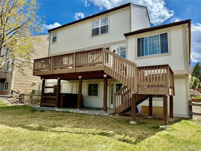 rear view of house featuring stairs, a yard, and a deck