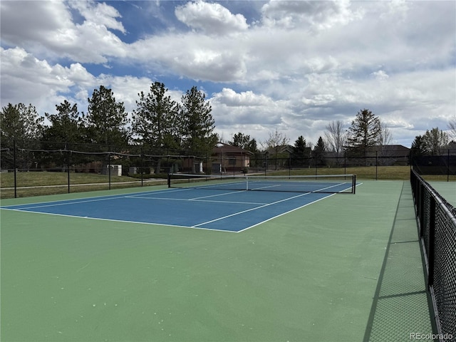 view of tennis court with fence and community basketball court