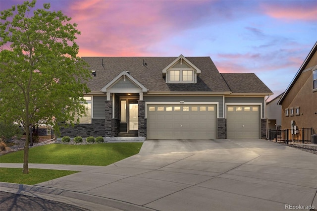 view of front of home featuring roof with shingles, concrete driveway, fence, a garage, and a front lawn