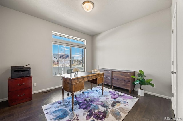 office featuring wood finished floors, visible vents, and baseboards