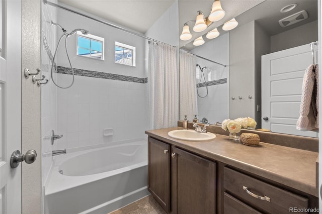 bathroom featuring visible vents, vanity, and shower / bath combo with shower curtain