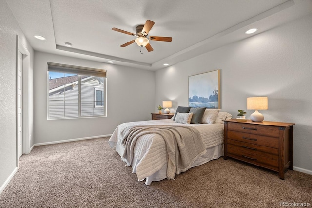 bedroom with recessed lighting, a raised ceiling, a ceiling fan, carpet flooring, and baseboards