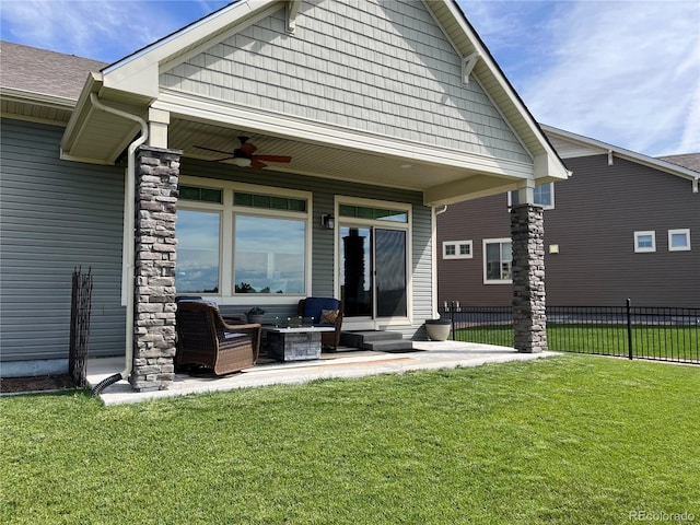 back of house featuring a ceiling fan, entry steps, a lawn, and fence