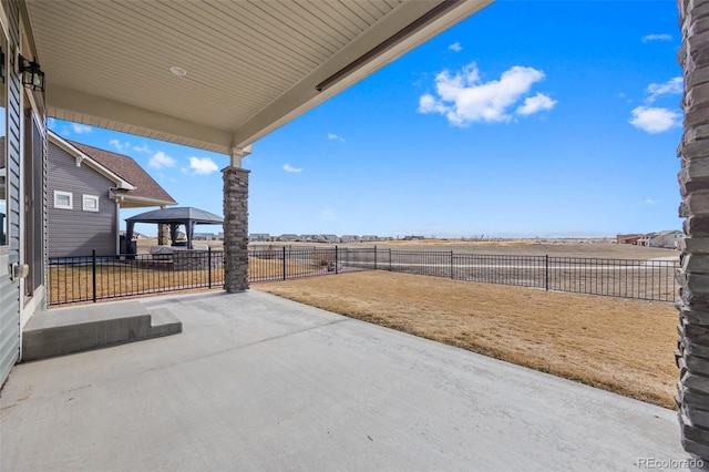 view of patio with a fenced backyard and a gazebo