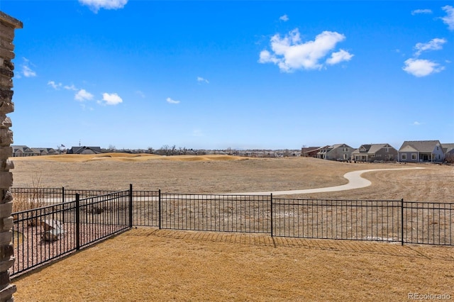 view of yard with a residential view and fence