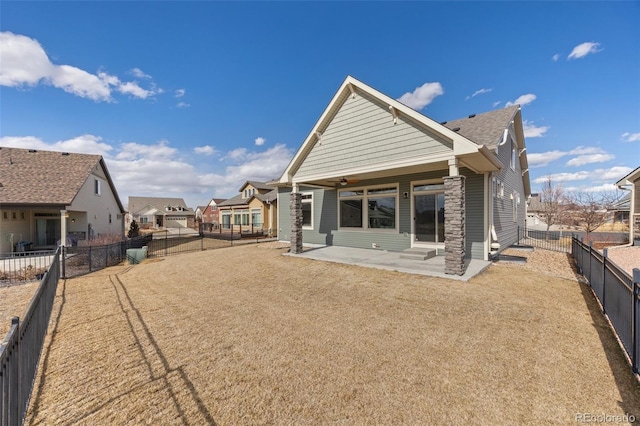 rear view of house with entry steps, a patio, ceiling fan, a fenced backyard, and a residential view