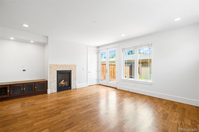 1934 S Sherman St, Denver, CO 80210 - unfurnished living room featuring wood finished floors, recessed lighting, and a warm lit fireplace