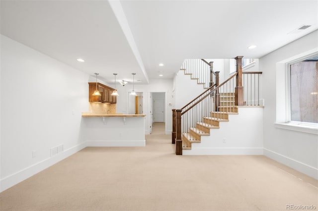 1934 S Sherman St, Denver, CO 80210 - unfurnished living room with stairway, light carpet, and recessed lighting