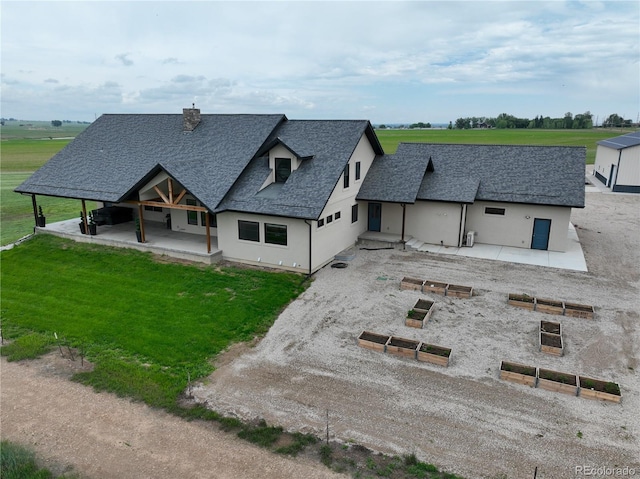6331 County Road 32, Platteville, CO 80651 - view of front of house featuring a shingled roof, a front yard, dirt driveway, a chimney, and stucco siding