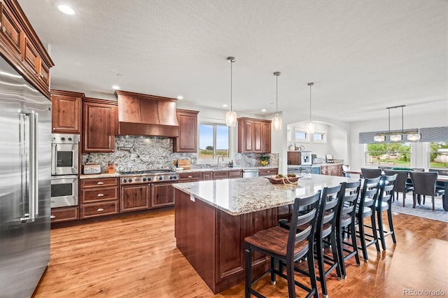 6331 County Road 32, Platteville, CO 80651 - kitchen featuring custom exhaust hood, stainless steel appliances, light wood-type flooring, a sink, and recessed lighting