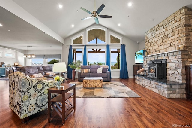 6331 County Road 32, Platteville, CO 80651 - living room featuring wood finished floors, ceiling fan, vaulted ceiling, a wood stove, and recessed lighting