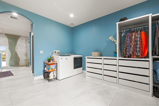 6331 County Road 32, Platteville, CO 80651 - laundry area with washing machine and dryer, arched walkways, recessed lighting, and baseboards
