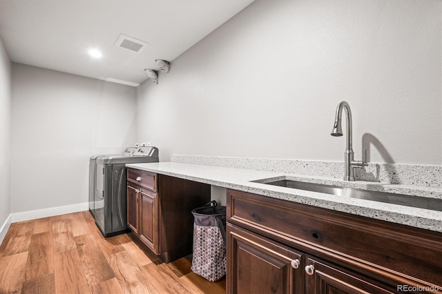 6331 County Road 32, Platteville, CO 80651 - washroom with washing machine and clothes dryer, light wood finished floors, cabinet space, and baseboards