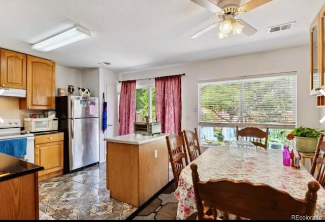 kitchen with white appliances and ceiling fan