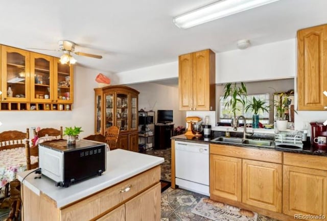 kitchen featuring ceiling fan, sink, and dishwasher