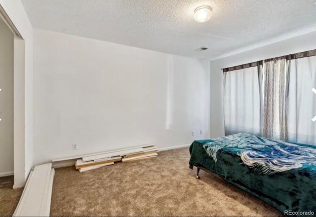 bedroom with carpet and a textured ceiling